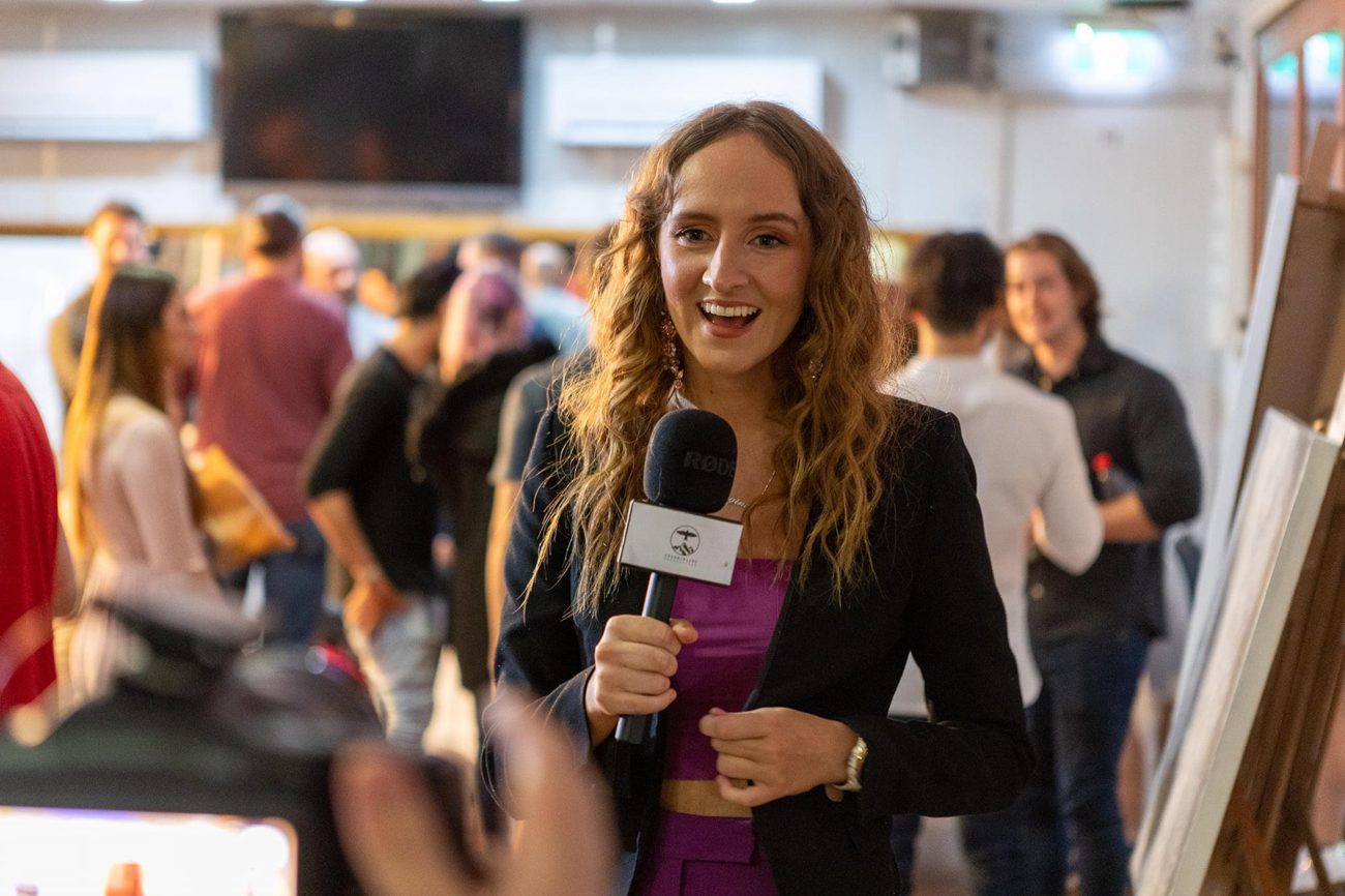 Georgina with a microphone at an event